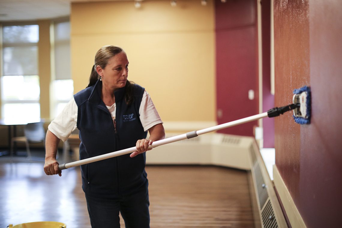 UMF Facilities Maintenance Lead Worker Laura Adams washes the walls.