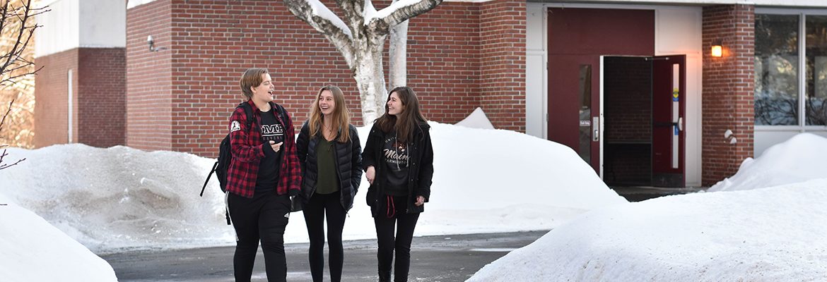 students walking on campus in the snow