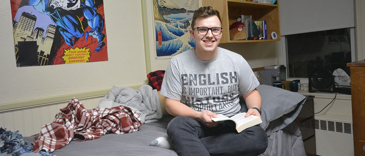 Student in a Scott Hall - North residence hall room