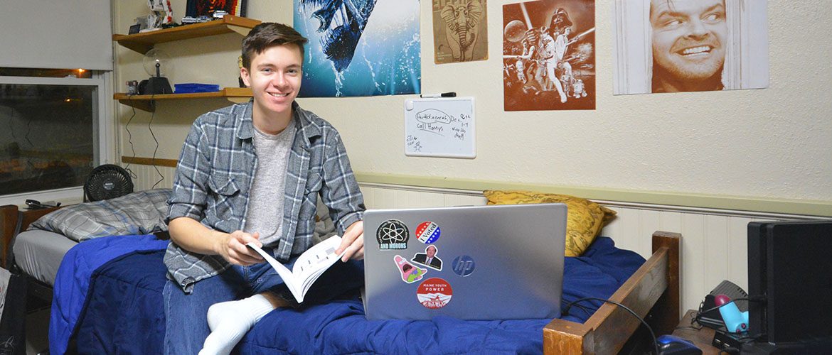 Student in a Scott Hall - North residence hall room