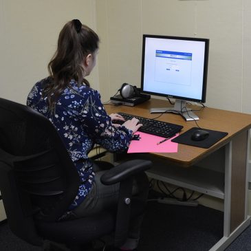 Student at one of twelve supervised testing stations at UMF Testing Services facility.