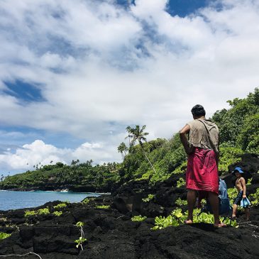 People look out to the Pacific Ocean from an island in Samoa.