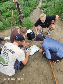 UMF students working on a river restoration project