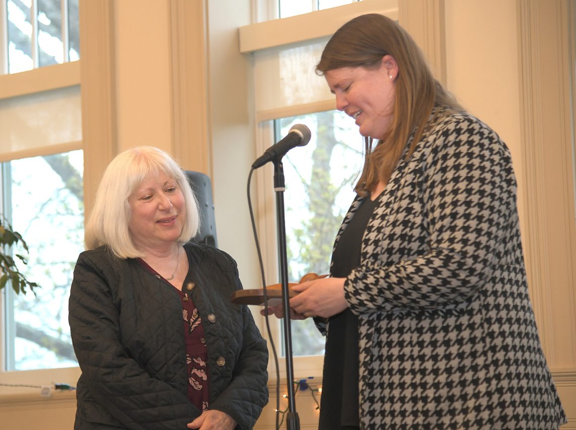UMF Professor Patti Bailie (left) receives Maine Environmental Education Association Lifetime Achievement Award from Olivia Griset (right), co-director of the MEEA.