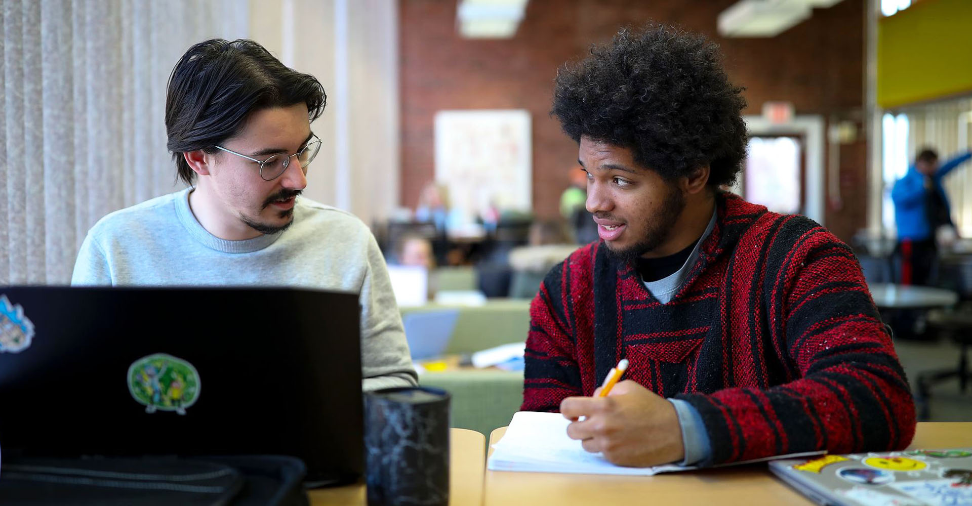 Two students working on a computer